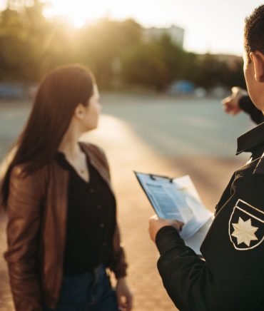 police-officer-shows-parking-place-to-driver-7DSTRWL-scaled.jpg